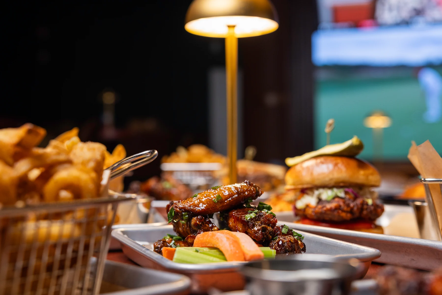 Wings, sandwiches and sides on a table at Peachtree Sporting Club