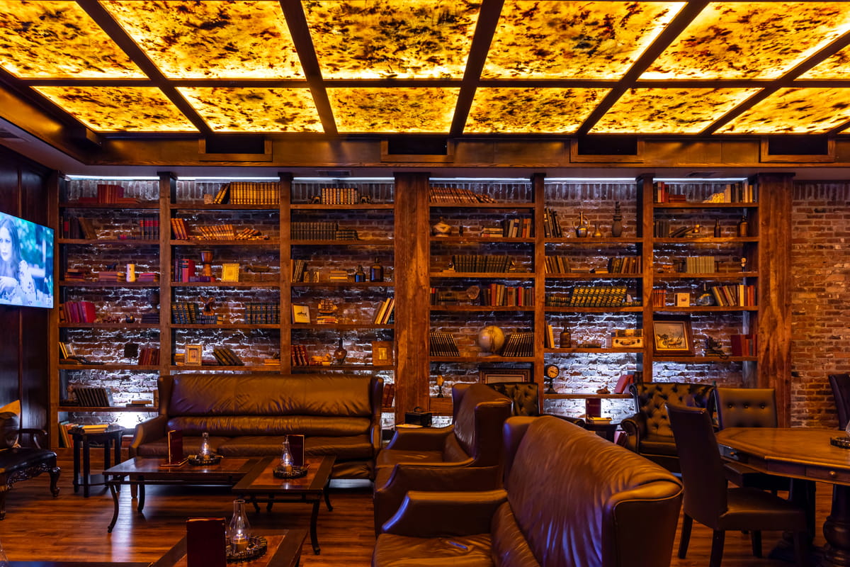 Leather seating, book-lined walls and an illuminated ceiling inside Red Phone Booth