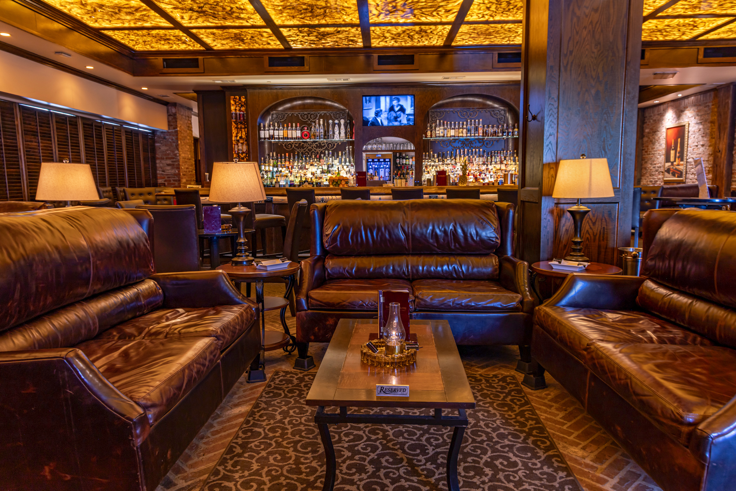 Leather lounge seating and the illuminated ceiling inside Red Phone Booth Downtown Atlanta