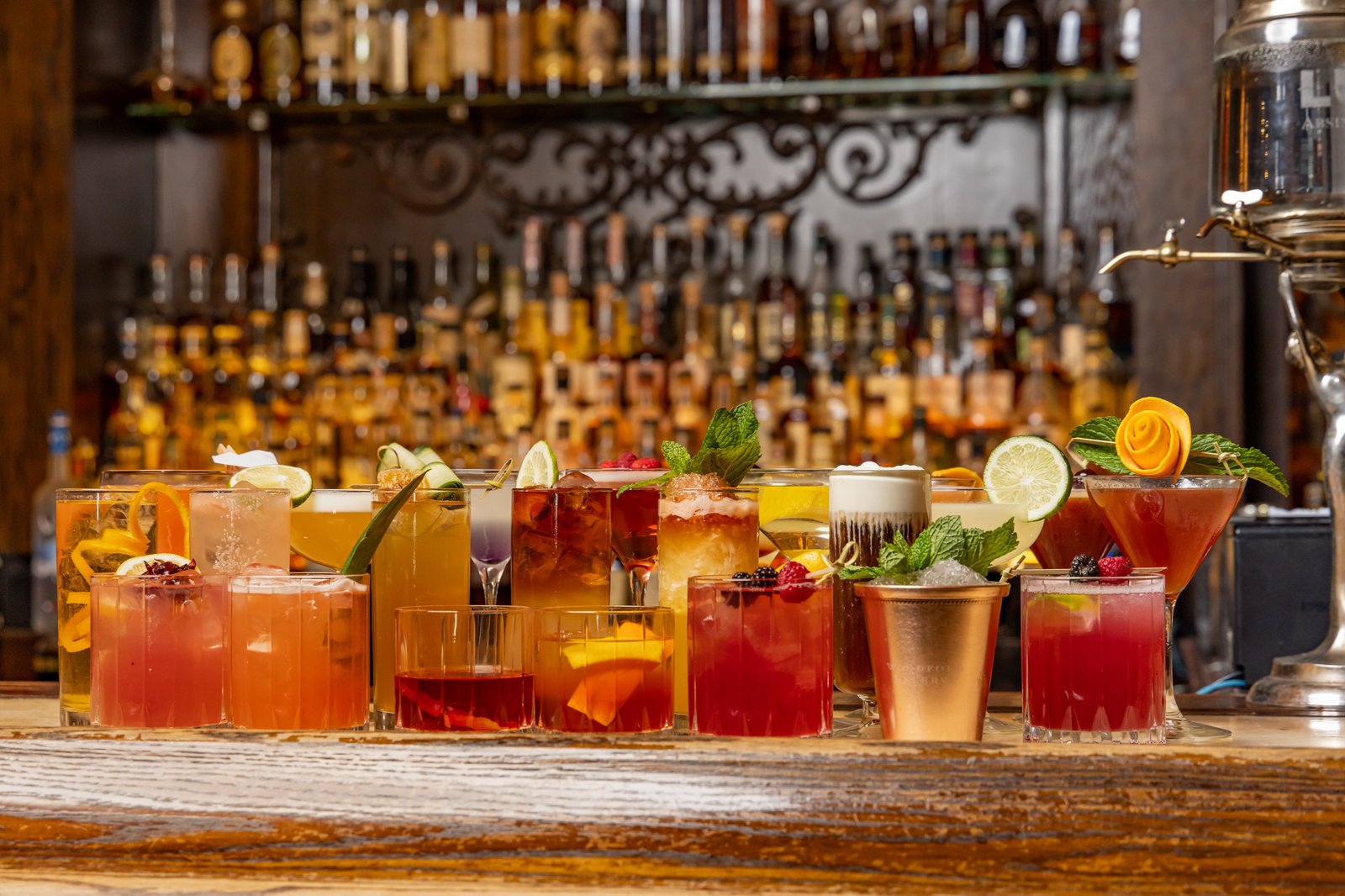 A colorful selection of Red Phone Booth cocktails arranged across the bar